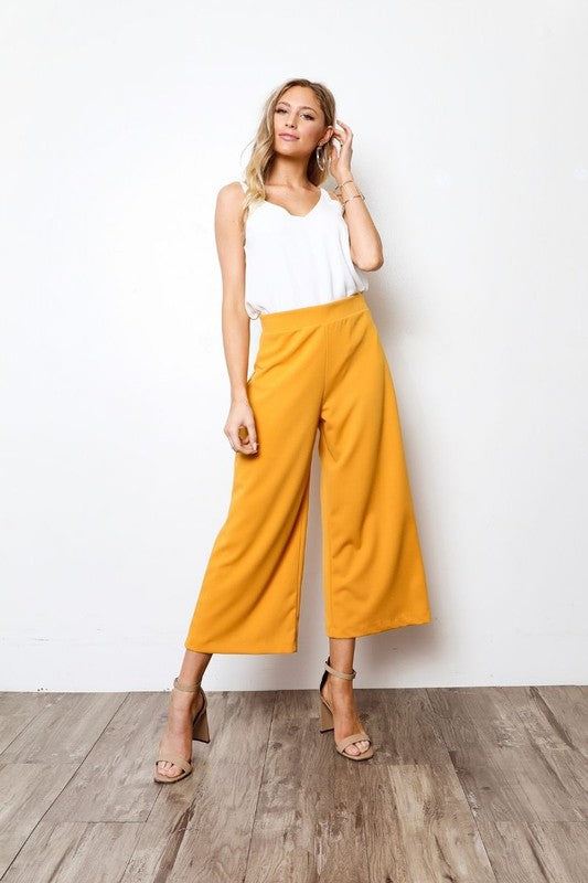High waisted pants with cropped hem, wide legs, and relaxed fit.